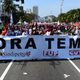 Residents of Rio de Janeiro demonstrate against interim president Michel Temer, political upheaval, corruption and the cost of the Rio 2016 Olympics Games, in front of the Copacabana Palace Hotel on August 5, 2016. Thousands of Brazilians angry at political upheaval, corruption and the cost of the Rio Olympics blocked traffic in protests hours before the gala opening ceremony. Most people came to vent anger at center-right interim president Michel Temer who took power in May on the suspension of the elected leftist president, Dilma Rousseff, for an impeachment trial that her supporters claim amounts to a coup.